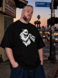 Bruce modeling the black GlitchTard luxury retard meme shirt at sunset on Baseline Avenue