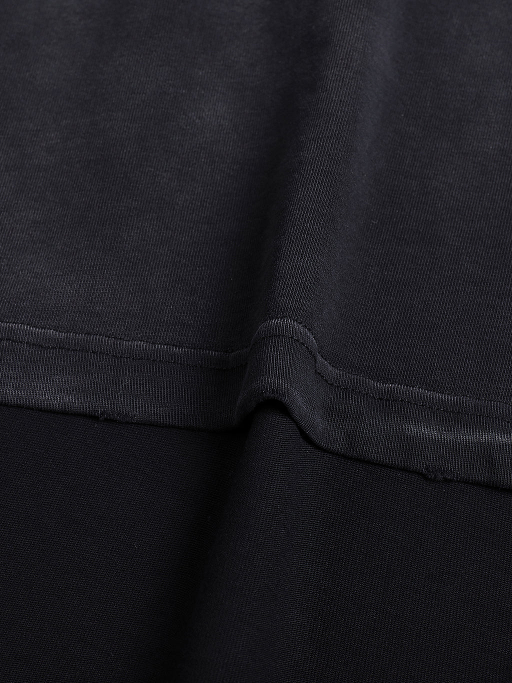 Close view of the 260 GSM cotton texture and reinforced stitching on the hand-frayed luxury tee