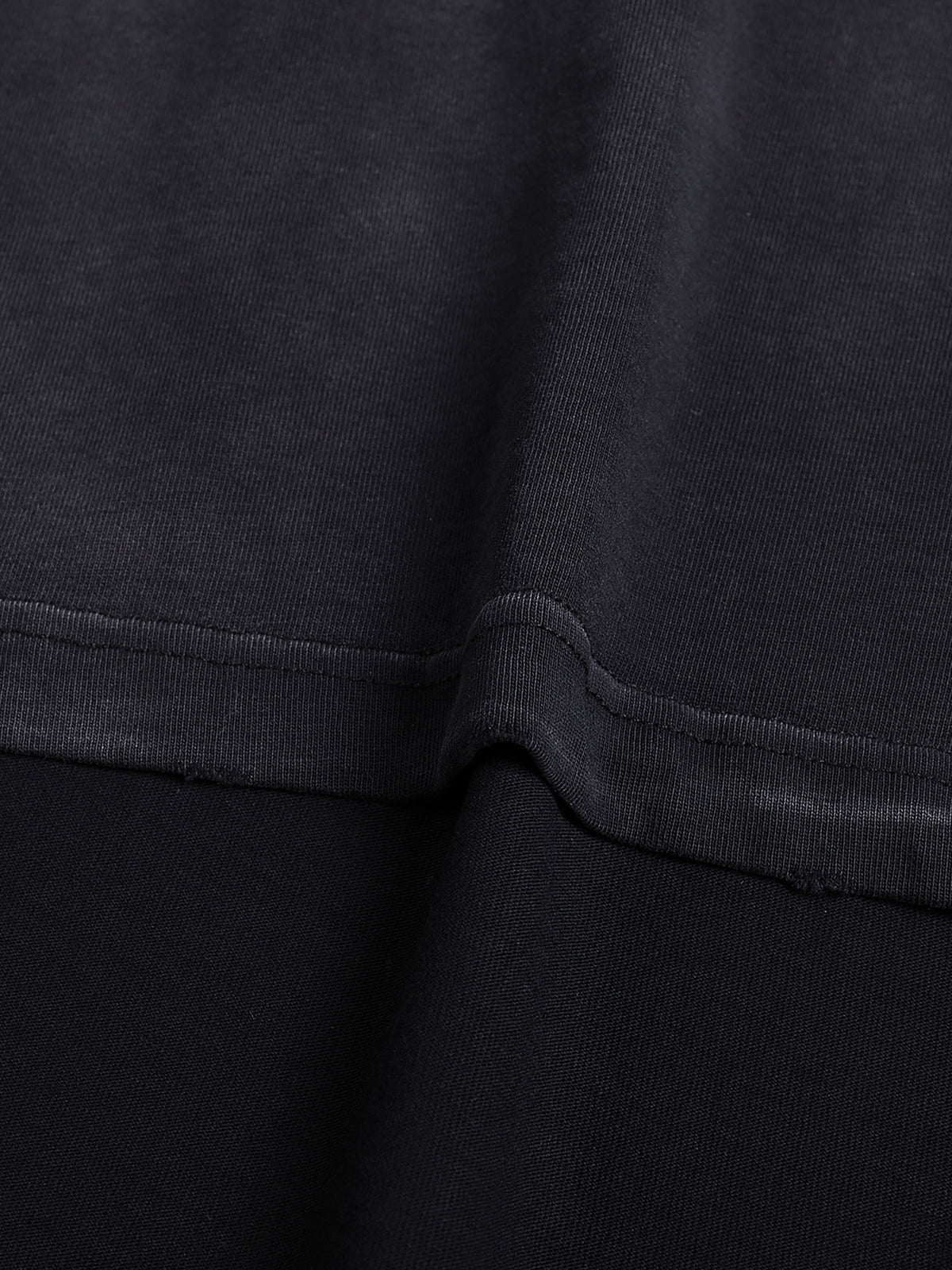 Close view of the 260 GSM cotton texture and reinforced stitching on the hand-frayed luxury tee
