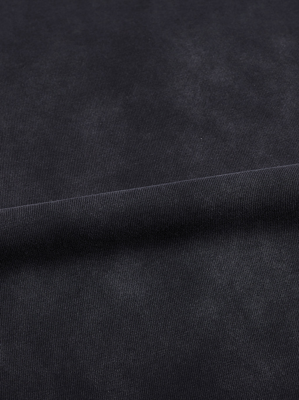 Macro detail of vintage black-gray washed 100% cotton fabric