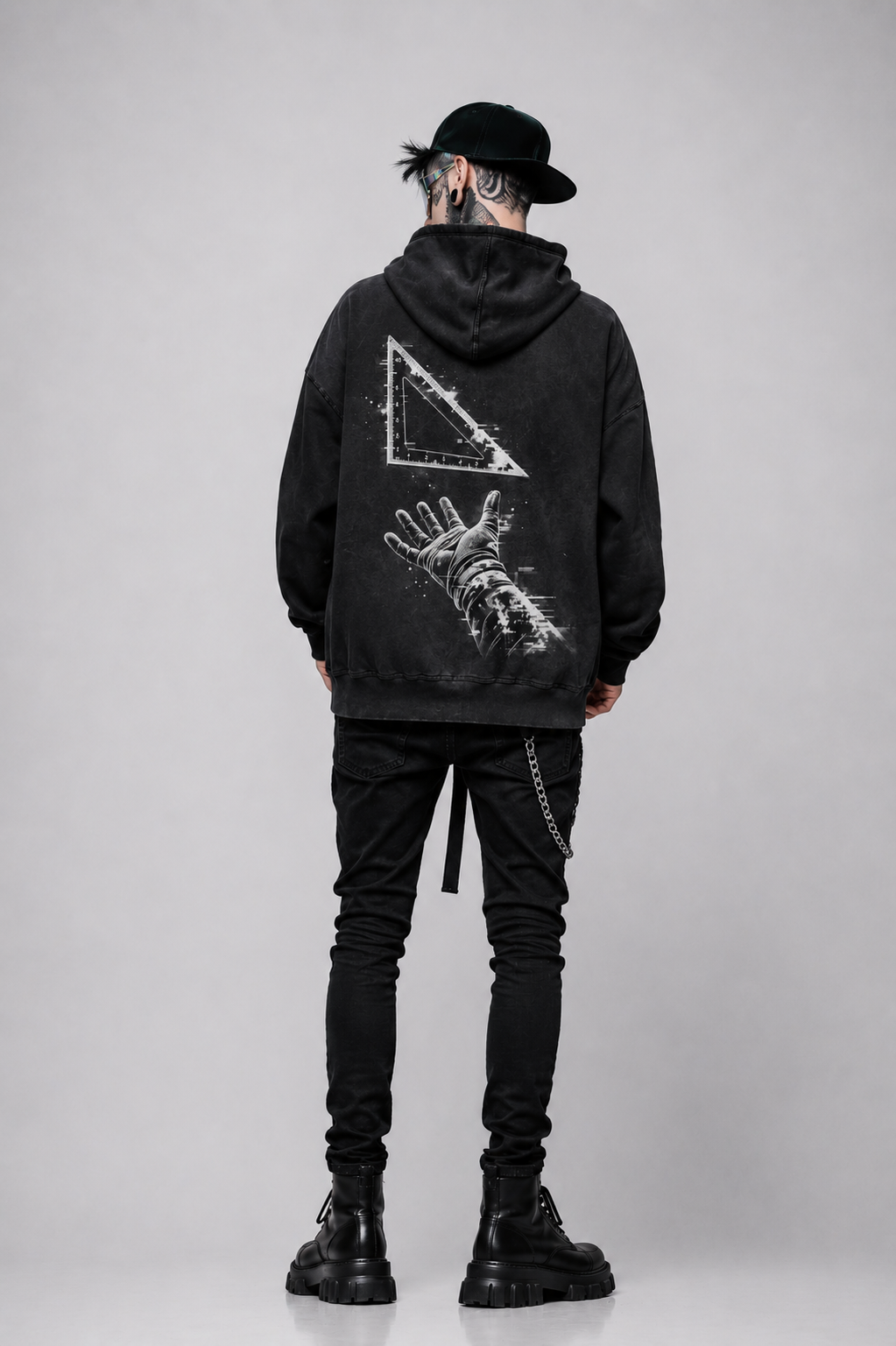 Rear view of model wearing the black Speed Square King Luxury Hoodie with Cybertruck speed square artwork across the back